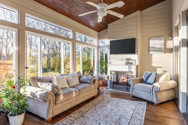 sunroom featuring a fireplace, a wealth of natural light, lofted ceiling, and wood ceiling