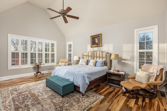 bedroom featuring multiple windows, ceiling fan, high vaulted ceiling, and dark hardwood / wood-style floors