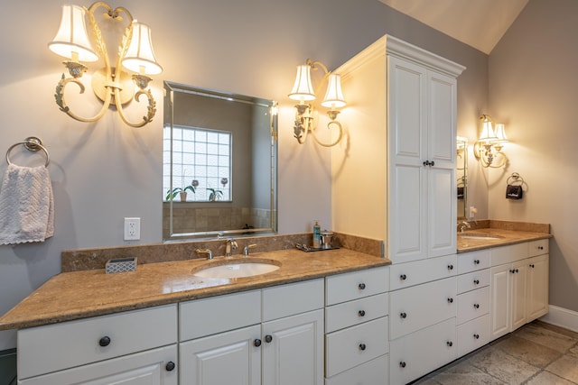 bathroom featuring vanity and lofted ceiling