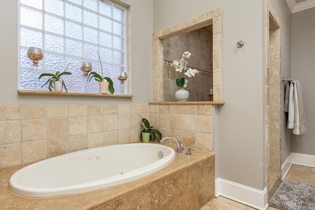 bathroom with a relaxing tiled tub and ornamental molding