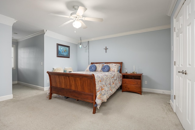 carpeted bedroom featuring ceiling fan and ornamental molding