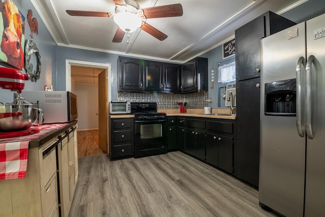 kitchen featuring black stove, stainless steel fridge with ice dispenser, light hardwood / wood-style flooring, crown molding, and decorative backsplash