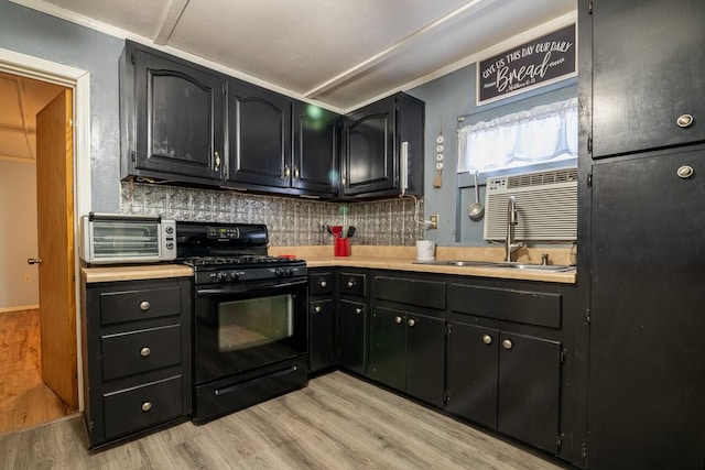 kitchen featuring backsplash, sink, light hardwood / wood-style floors, ornamental molding, and gas stove