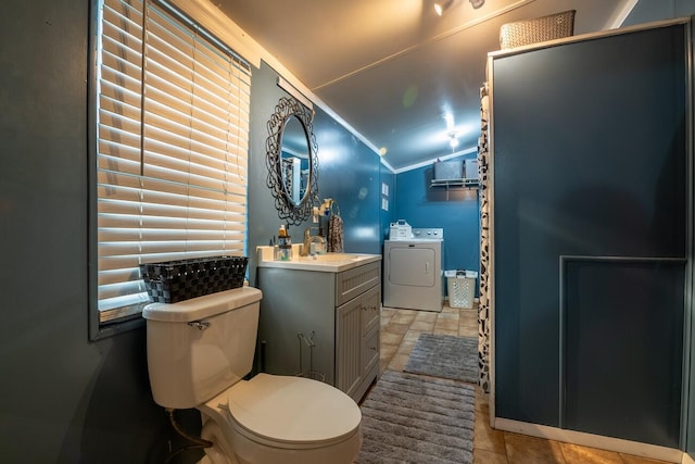 bathroom featuring tile patterned floors, vanity, washer and clothes dryer, toilet, and lofted ceiling