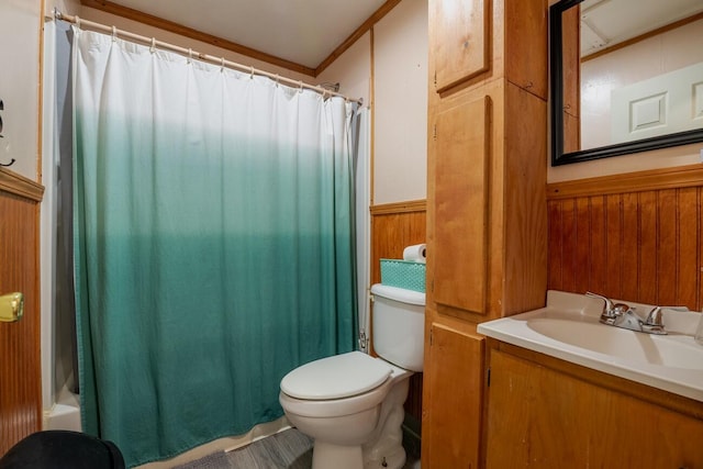 full bathroom featuring crown molding, wooden walls, vanity, and toilet