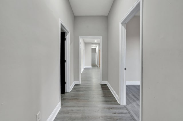 corridor with wood-type flooring