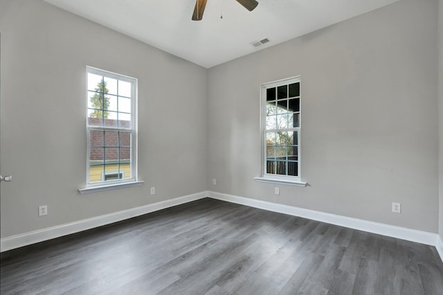 empty room with dark hardwood / wood-style floors and ceiling fan