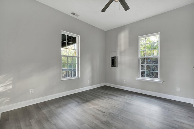 empty room with dark hardwood / wood-style floors and ceiling fan