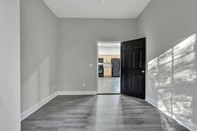 spare room with hardwood / wood-style flooring