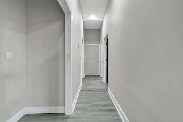 hall with light hardwood / wood-style flooring