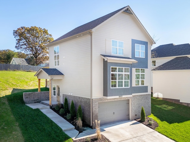 view of front of home with a garage and a front yard