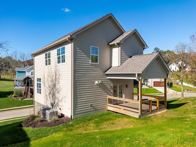 back of house with a yard, french doors, and a deck