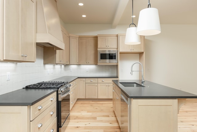 kitchen with custom range hood, stainless steel appliances, sink, light hardwood / wood-style floors, and hanging light fixtures