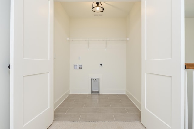 laundry area featuring light tile patterned floors, washer hookup, and hookup for an electric dryer