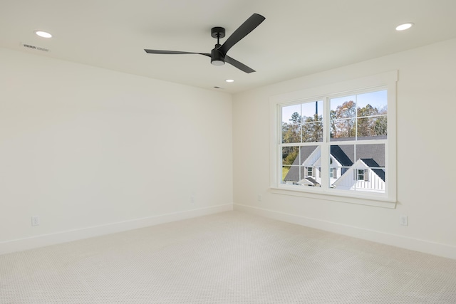 carpeted spare room featuring ceiling fan