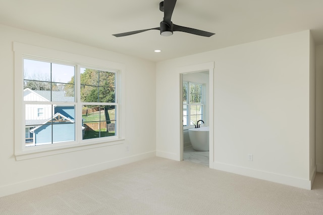 unfurnished room featuring light carpet and ceiling fan