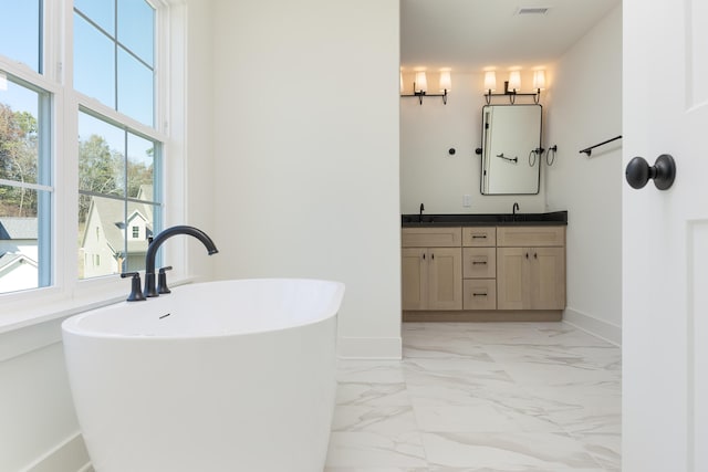 bathroom with vanity and a bath