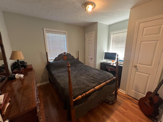 bedroom featuring hardwood / wood-style floors and a textured ceiling