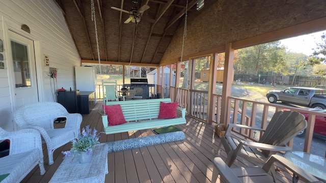 sunroom featuring vaulted ceiling and ceiling fan