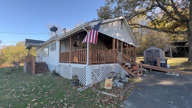 view of property exterior featuring a porch and a storage unit