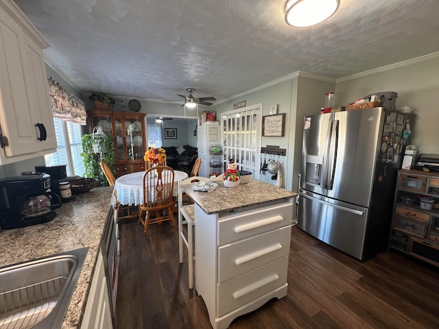 kitchen featuring white cabinets, stainless steel refrigerator with ice dispenser, a center island, and dark hardwood / wood-style flooring