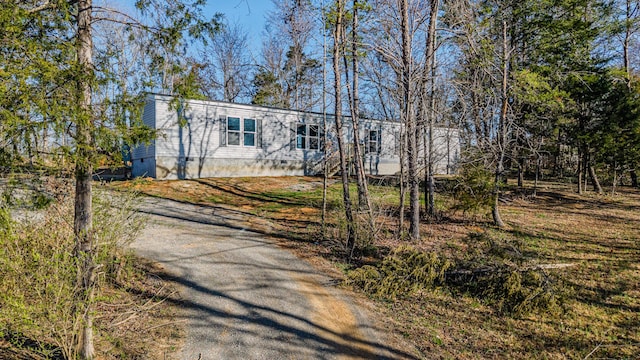 view of front of home featuring crawl space and aphalt driveway