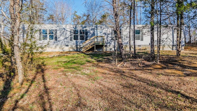 back of house with stairs and crawl space