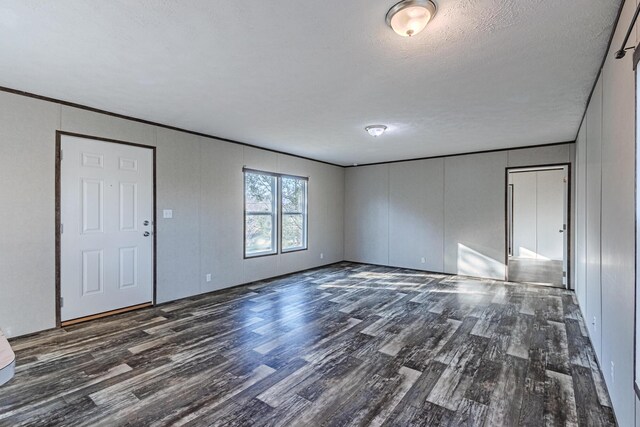 unfurnished room featuring wood finished floors and a textured ceiling