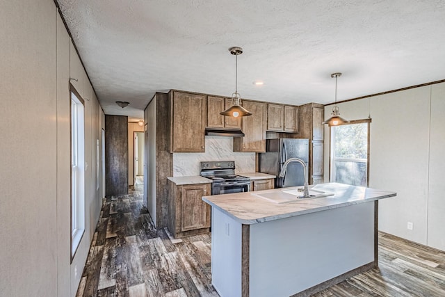 kitchen featuring light countertops, range with electric stovetop, freestanding refrigerator, dark wood-style floors, and a sink