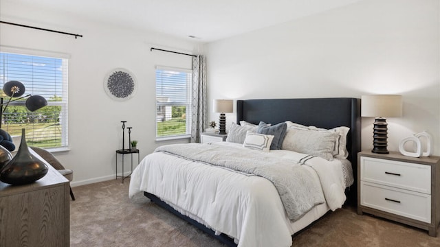 bedroom featuring multiple windows and dark colored carpet