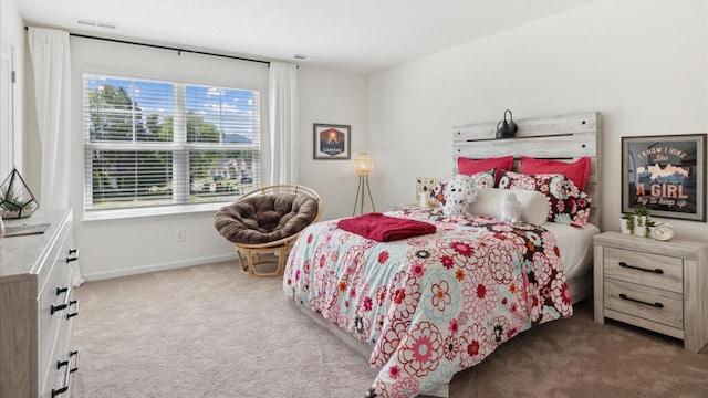 bedroom featuring light carpet