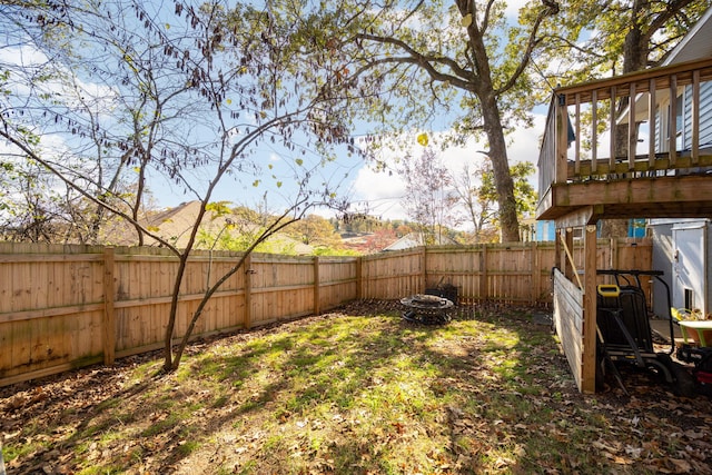 view of yard with a fire pit and a wooden deck