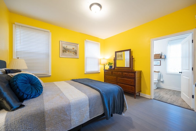 bedroom featuring wood-type flooring and ensuite bath