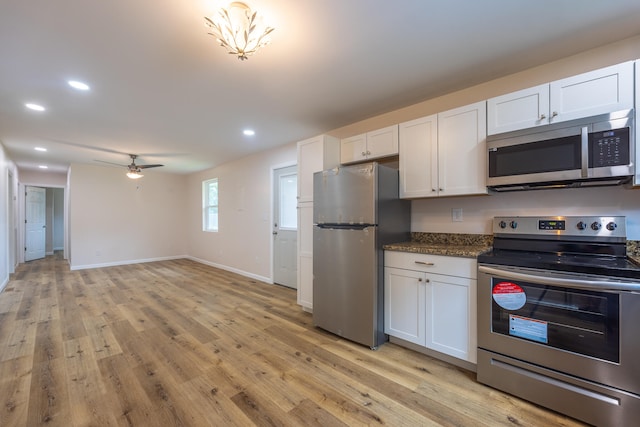 kitchen featuring ceiling fan, white cabinetry, appliances with stainless steel finishes, and light hardwood / wood-style flooring