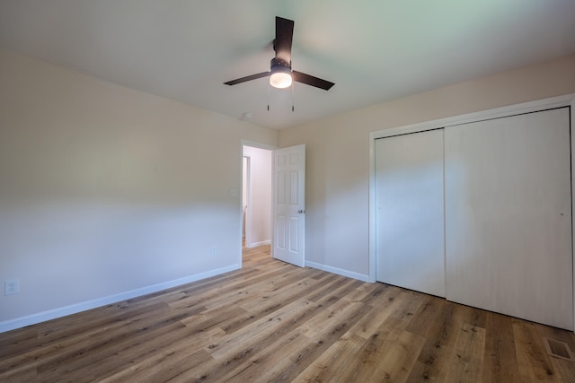 unfurnished bedroom with ceiling fan, a closet, and light hardwood / wood-style floors