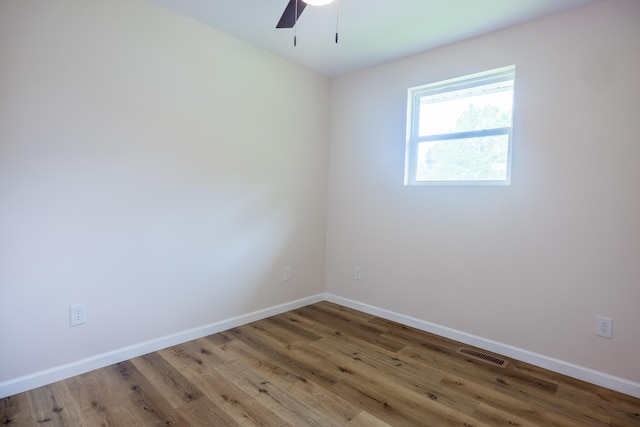 spare room with ceiling fan and hardwood / wood-style flooring