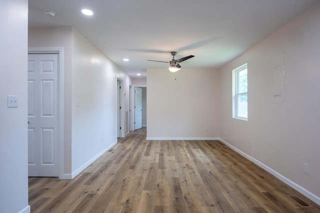 empty room with ceiling fan and wood-type flooring