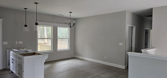 dining space with hardwood / wood-style flooring and a notable chandelier