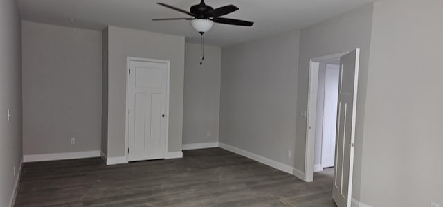 unfurnished bedroom featuring dark hardwood / wood-style flooring and ceiling fan