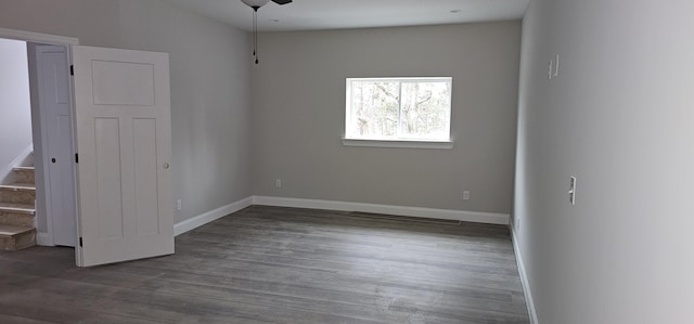 spare room featuring ceiling fan and dark hardwood / wood-style flooring