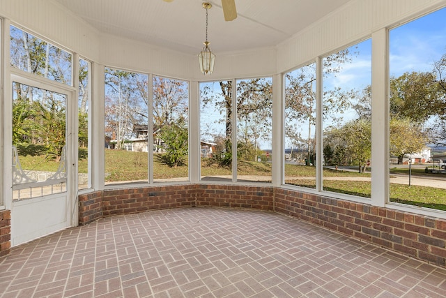 unfurnished sunroom with ceiling fan and a healthy amount of sunlight