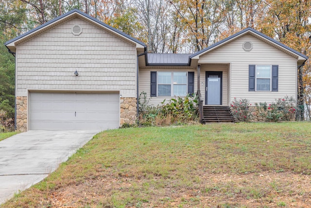 view of front of home with a front yard and a garage