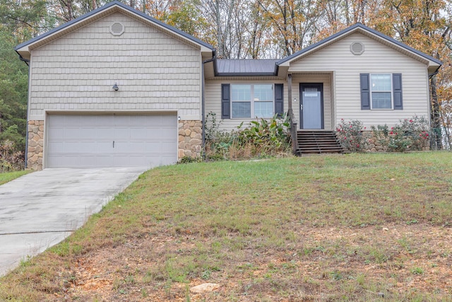 view of front of property featuring a garage and a front lawn