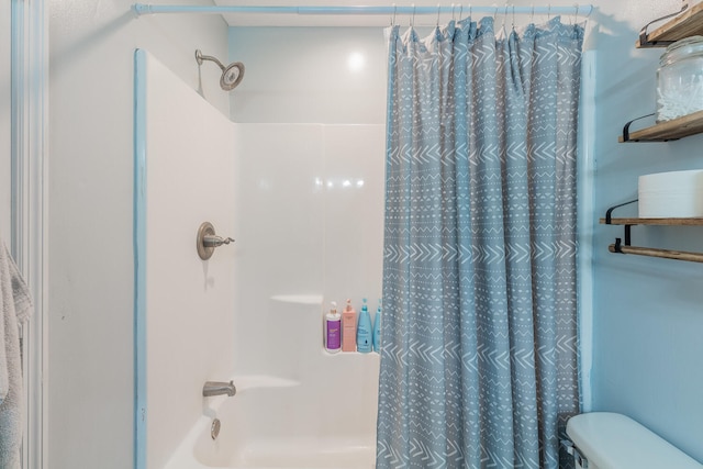 bathroom featuring shower / bath combo and toilet