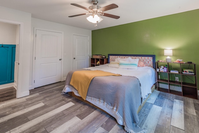 bedroom with wood-type flooring and ceiling fan