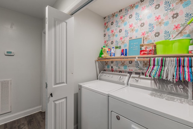 washroom with washing machine and dryer and dark hardwood / wood-style floors