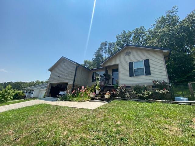 view of front of property with a front yard and a garage