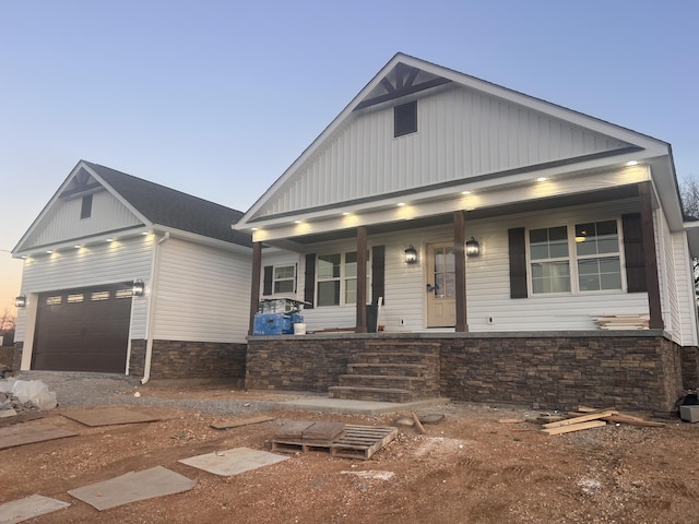 view of front facade with a garage and covered porch