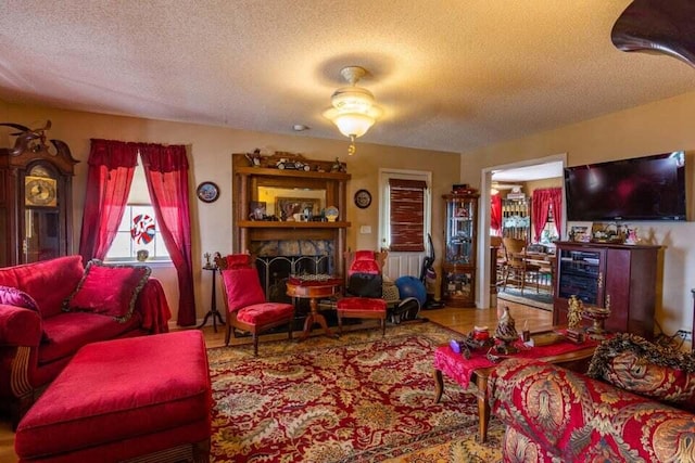 living room with a textured ceiling and ceiling fan