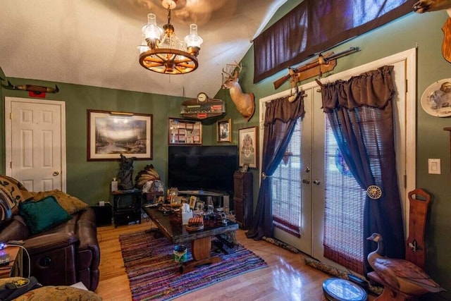 living room featuring a chandelier, light wood-type flooring, and french doors